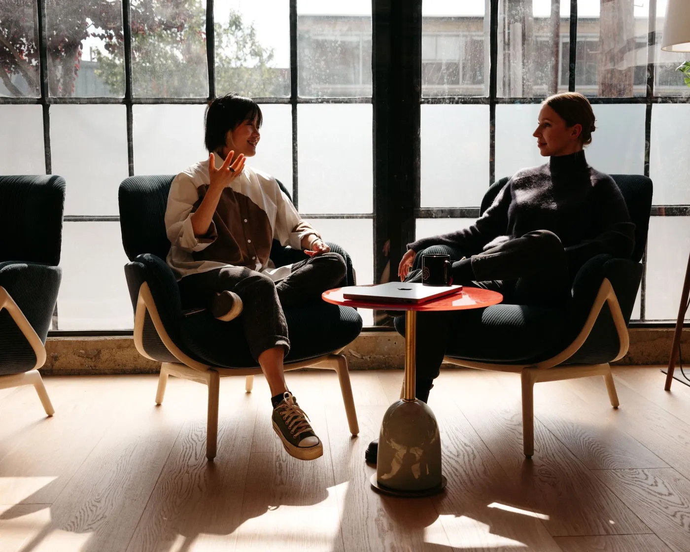 Two people having a thoughtful conversation in a quiet room